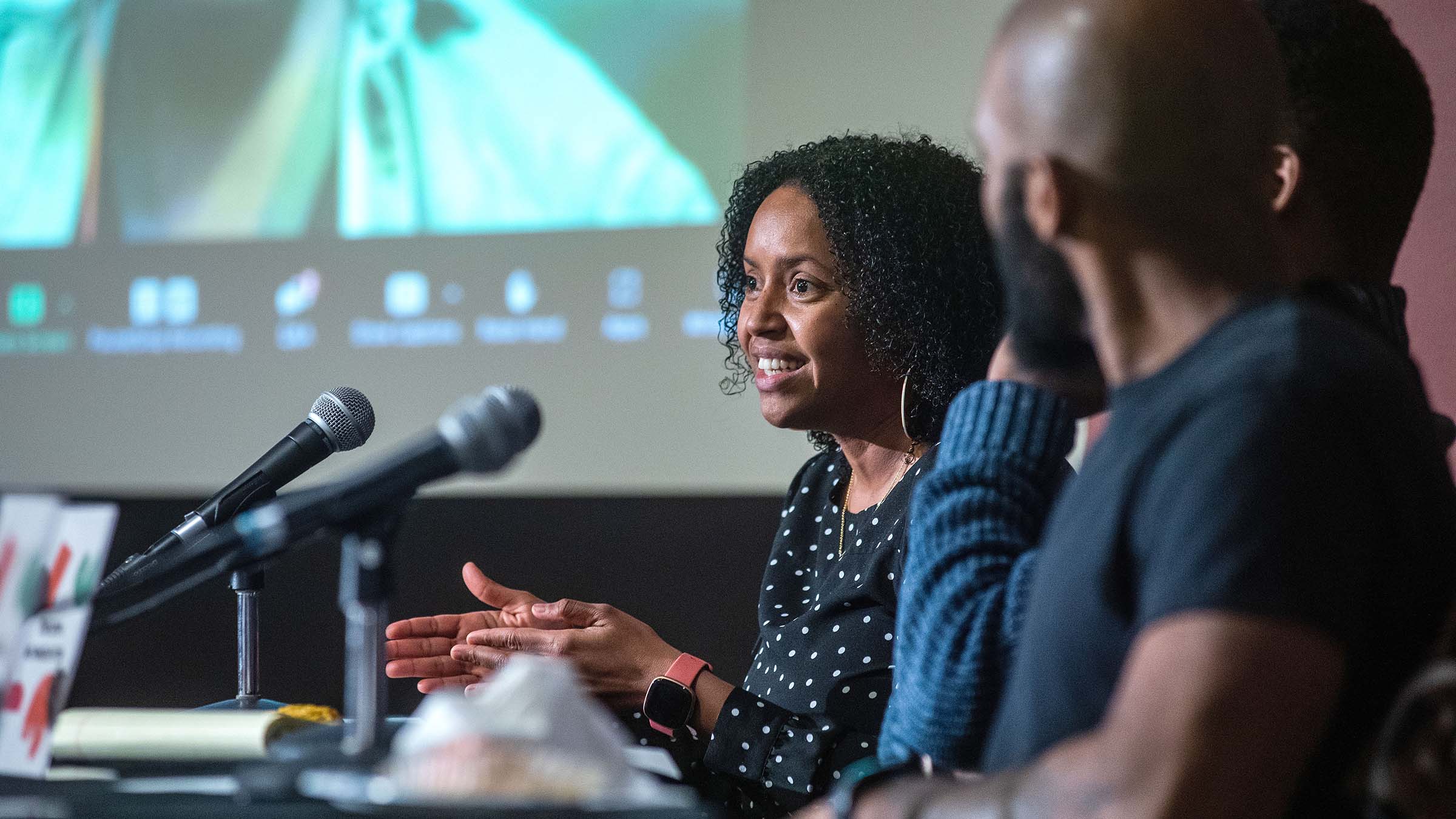 Assistant Professor of Chemistry Krystle McLaughlin sitting at a table in front of microphones