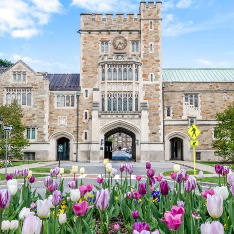 Front of the Taylor Hall Gate: a large stone building with the entrance to campus
