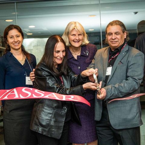 Several people, including President Bradley, cutting a ribbon with a large pair of scissors at the Chinery Neuroscience Laboratory Ribbon Cutting & Dedication.
